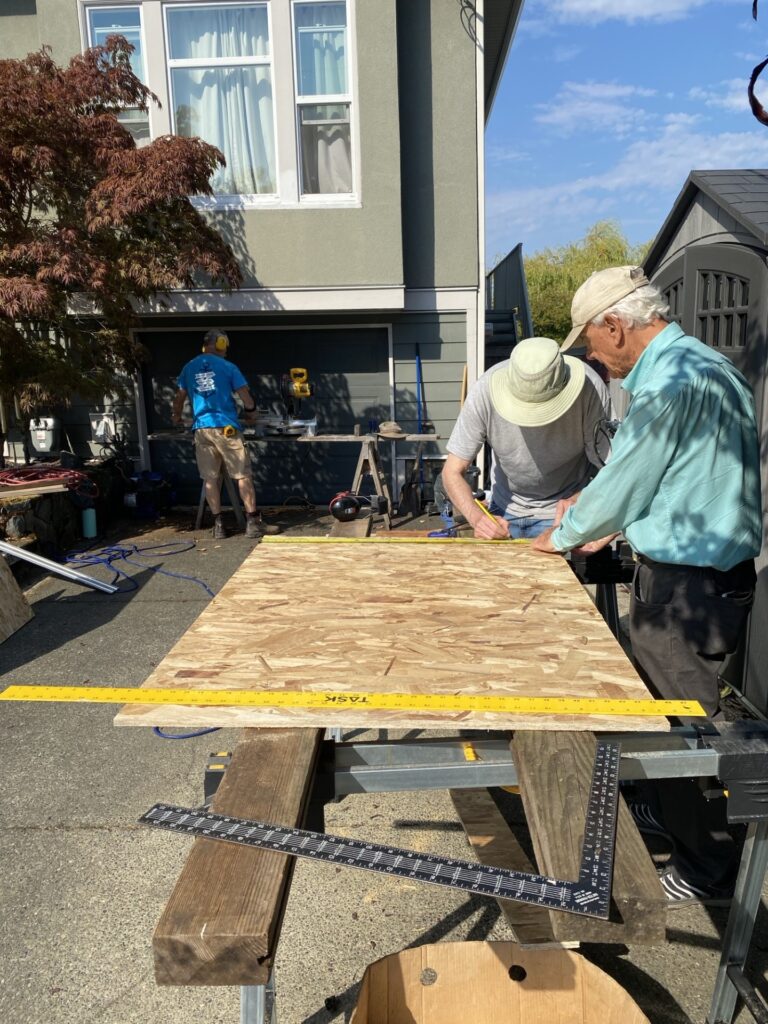 Esquimalt Men's Shed members participating in pantry building.