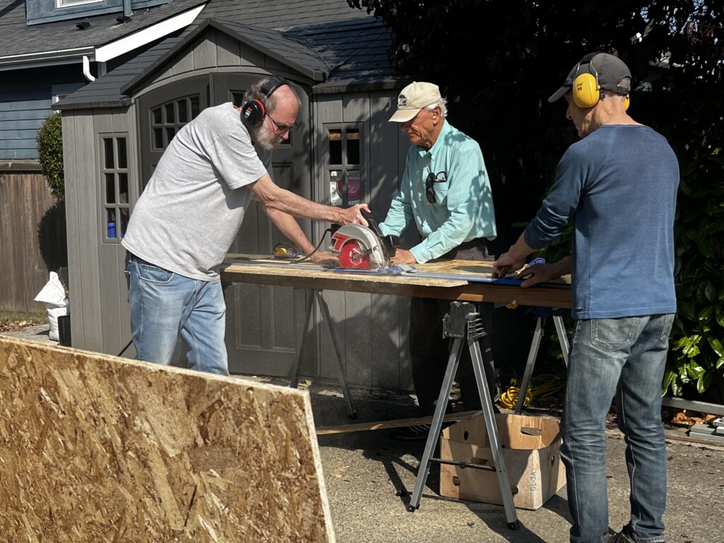 Esquimalt Men's Shed members participating in pantry building.