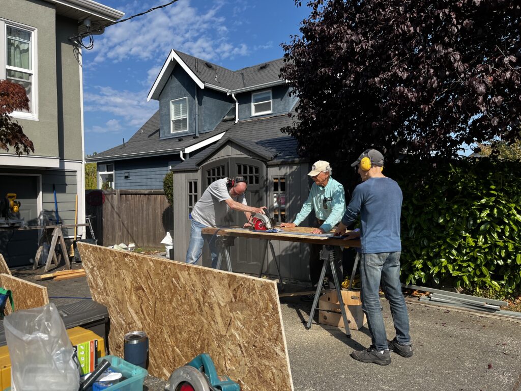 Esquimalt Men's Shed members participating in pantry building.
