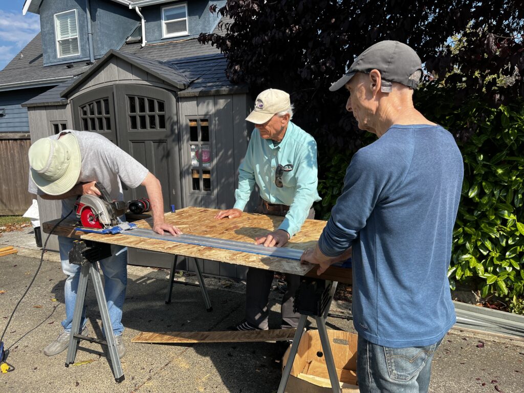Esquimalt Men's Shed members participating in pantry building.